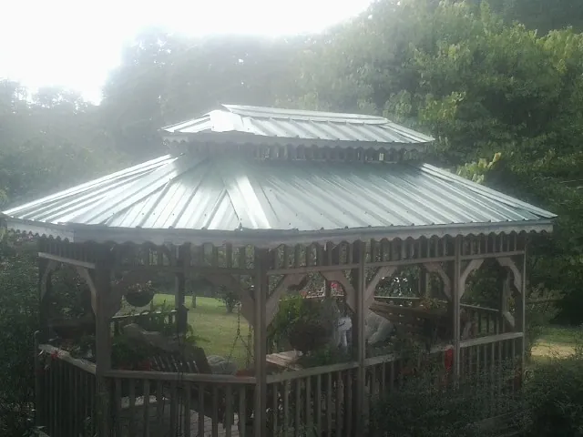Two tier green metal roof on a garden gazebo in Crisfield